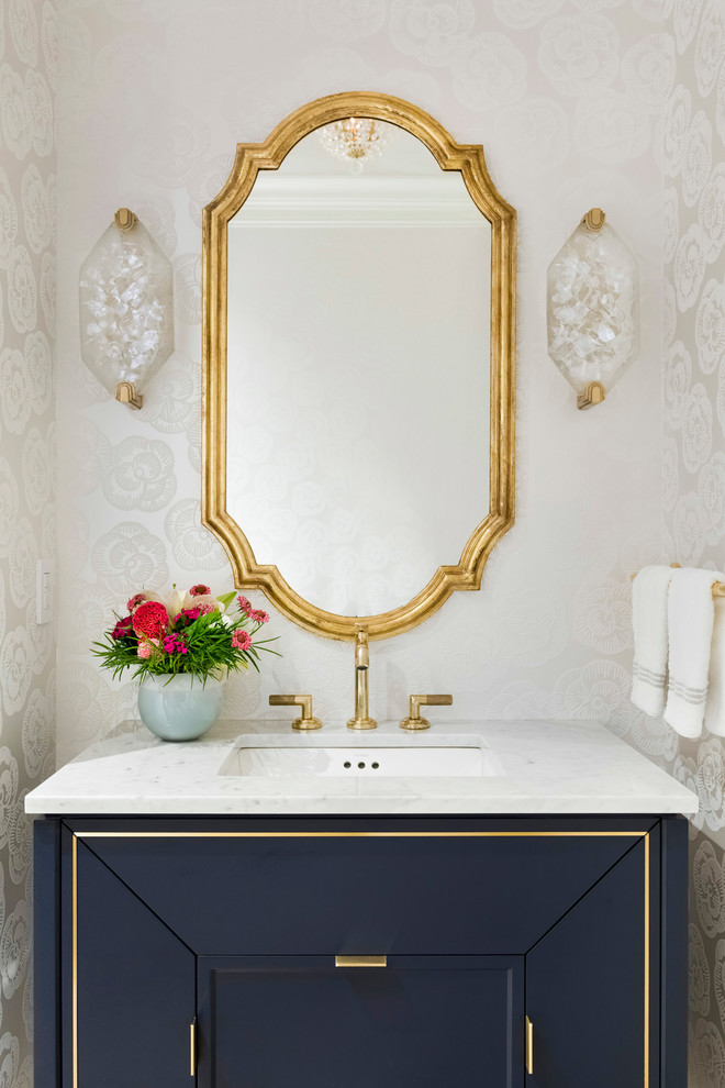 Traditional powder room in Minneapolis with beige walls, an undermount sink, grey benchtops, black cabinets, marble benchtops, wallpaper, furniture-like cabinets and a freestanding vanity.