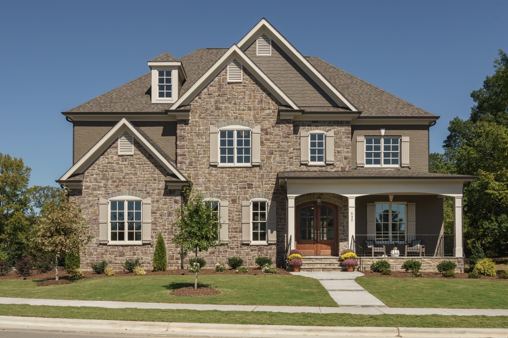 Design ideas for a large transitional two-storey brown house exterior in Raleigh with stone veneer.