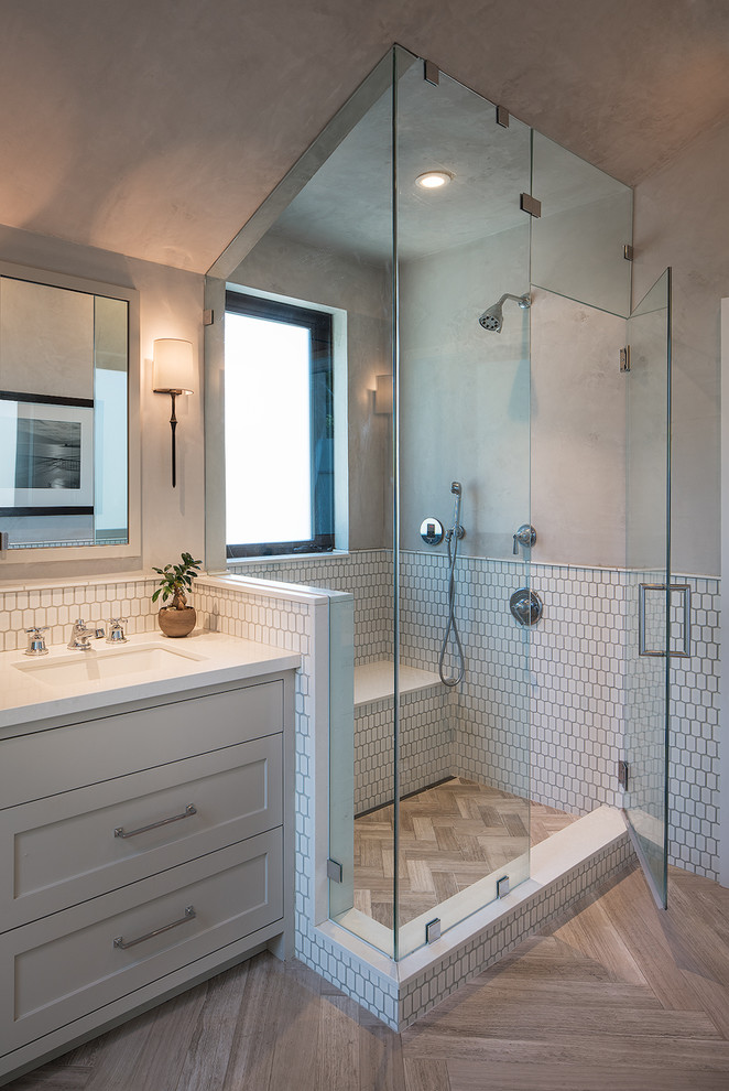 Design ideas for a transitional master bathroom in San Francisco with shaker cabinets, grey cabinets, a corner shower, white tile, beige walls, an undermount sink, beige floor and a hinged shower door.