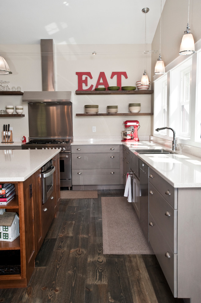 Open concept kitchen - large transitional l-shaped dark wood floor and brown floor open concept kitchen idea with a farmhouse sink, flat-panel cabinets, gray cabinets, quartz countertops, stainless steel appliances and an island