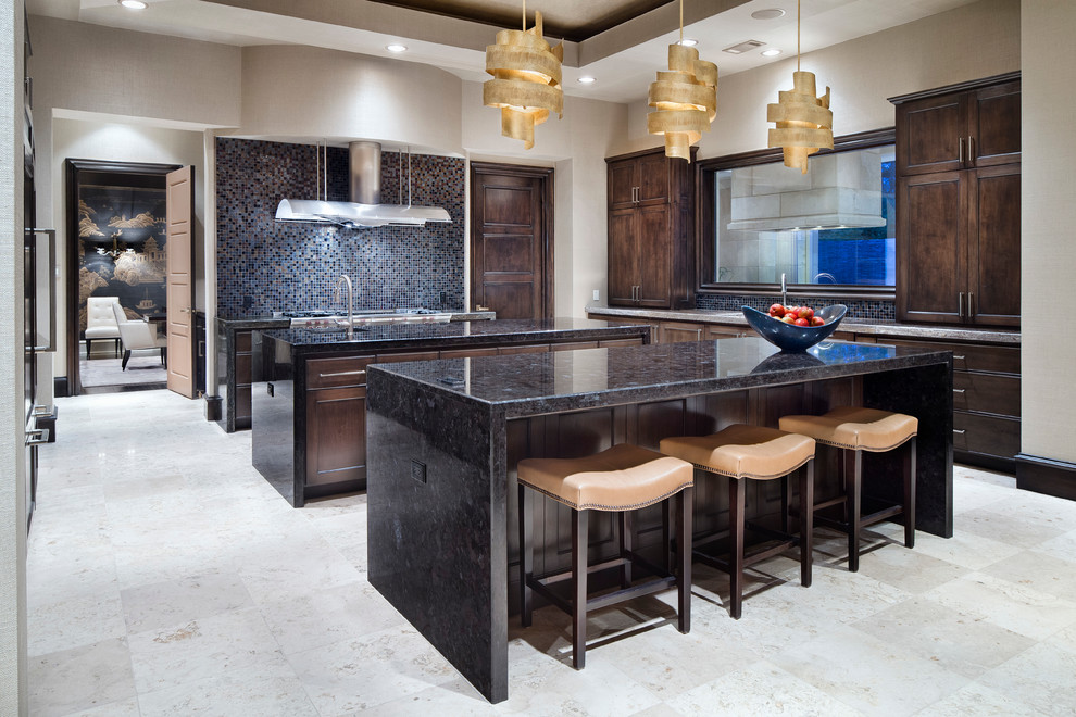 Photo of a mediterranean galley separate kitchen in Houston with recessed-panel cabinets, dark wood cabinets, multi-coloured splashback, mosaic tile splashback, stainless steel appliances and multiple islands.