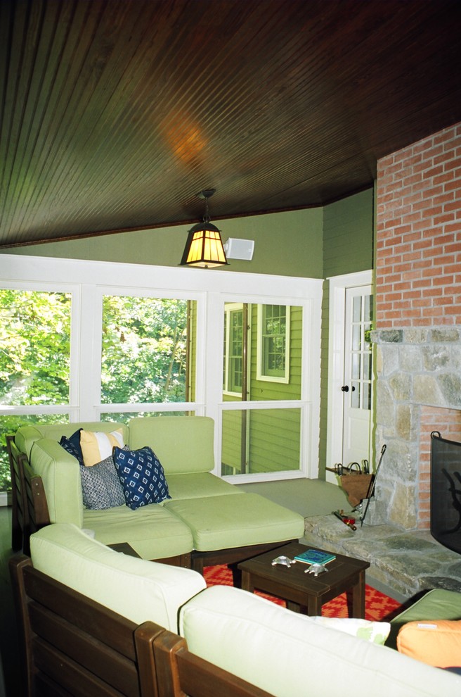 Mid-sized eclectic backyard screened-in verandah in New York with a roof extension.