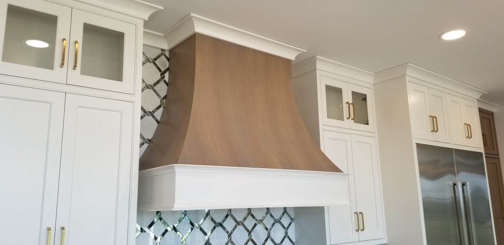 Large transitional kitchen photo with beaded inset cabinets, white cabinets, quartz countertops, metallic backsplash, stainless steel appliances, an island and white countertops
