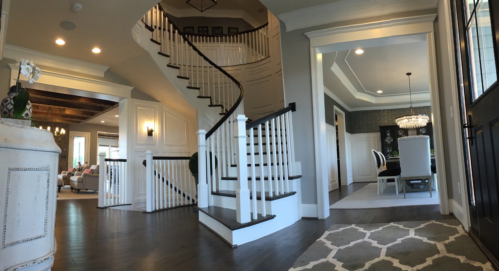 Inspiration for an expansive eclectic wood curved staircase in DC Metro with wood risers and wood railing.