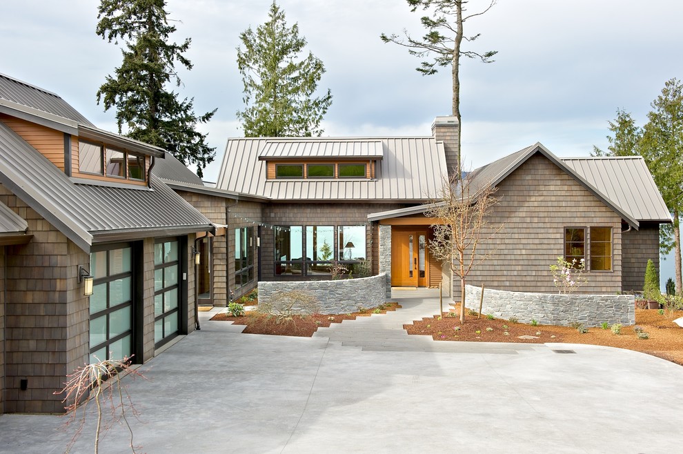 Design ideas for a beach style one-storey grey exterior in Seattle with wood siding, a gable roof and a metal roof.