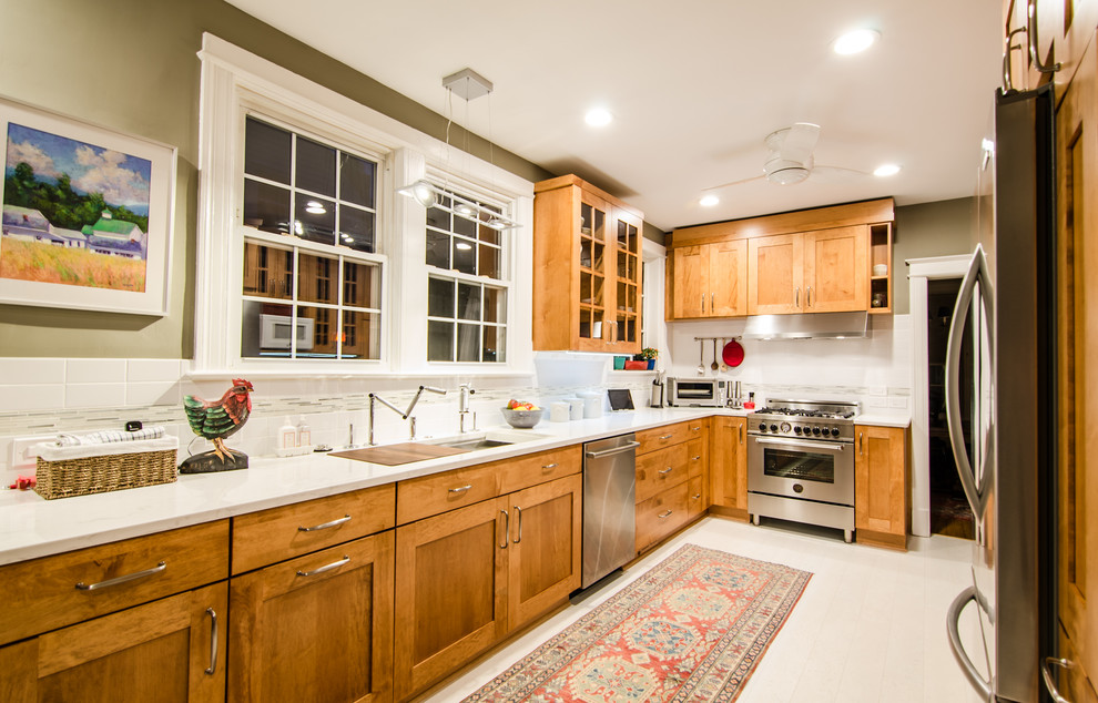 Example of a large transitional l-shaped cork floor eat-in kitchen design in DC Metro with an undermount sink, flat-panel cabinets, quartz countertops, white backsplash, glass tile backsplash, stainless steel appliances and no island