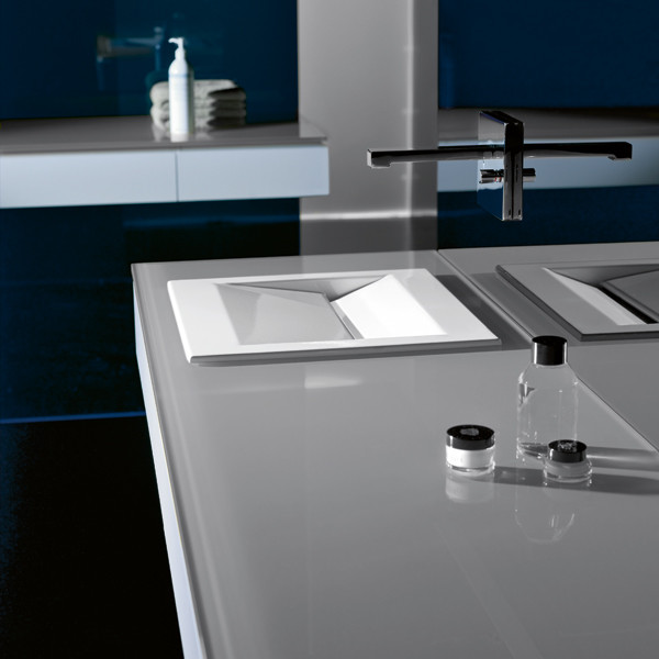This is an example of a contemporary bathroom in San Diego with glass benchtops, grey benchtops, a single vanity and blue walls.