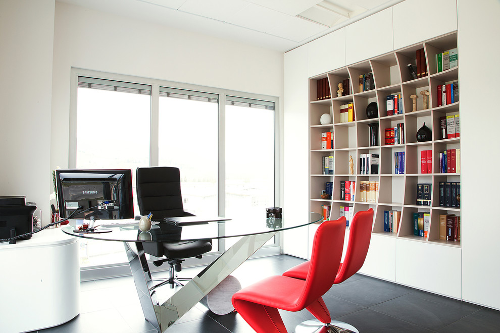 This is an example of a large contemporary study room in Other with white walls, concrete floors, black floor and a freestanding desk.