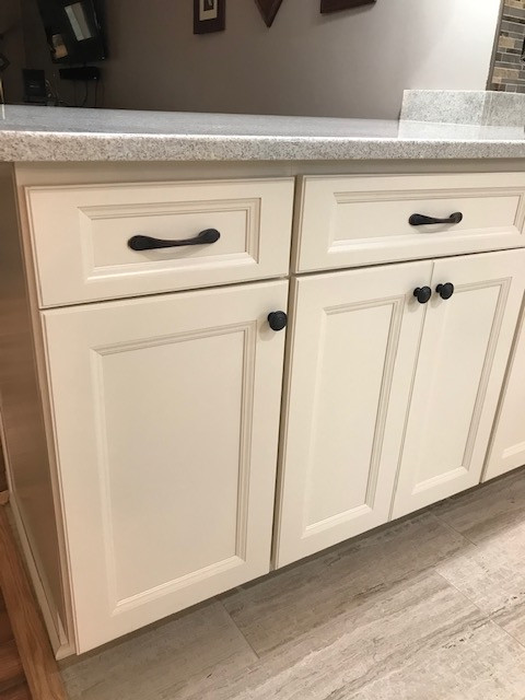 Inspiration for a mid-sized transitional galley porcelain tile and beige floor eat-in kitchen remodel with an undermount sink, flat-panel cabinets, beige cabinets, granite countertops, multicolored backsplash, mosaic tile backsplash, stainless steel appliances, a peninsula and white countertops