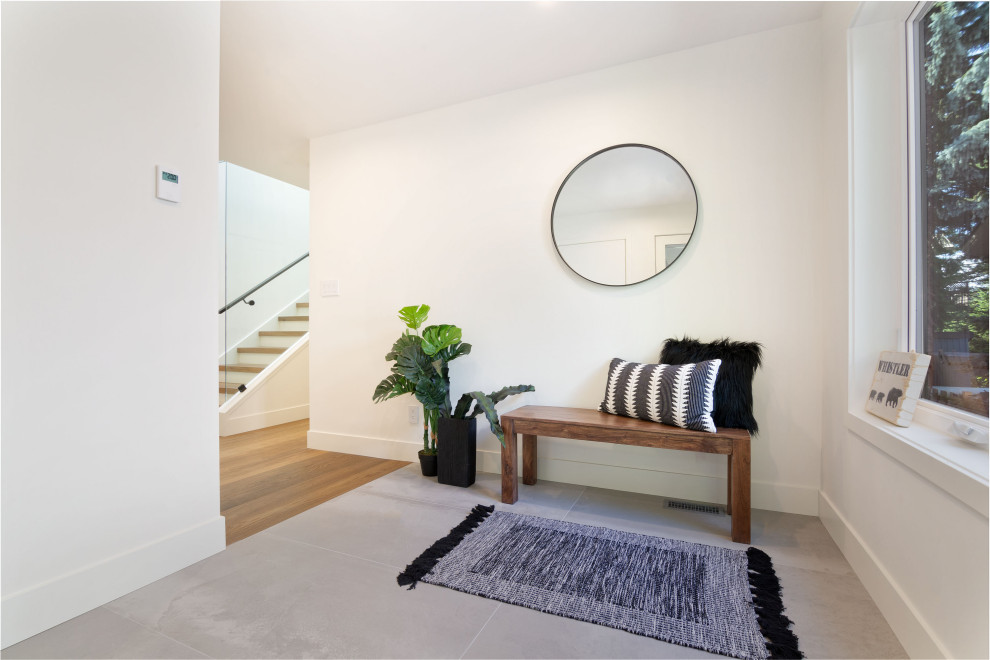 Foyer - mid-sized rustic medium tone wood floor and brown floor foyer idea with white walls and a medium wood front door