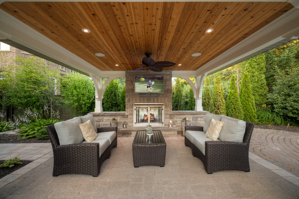 Design ideas for a transitional patio in Toronto with a fire feature and a gazebo/cabana.