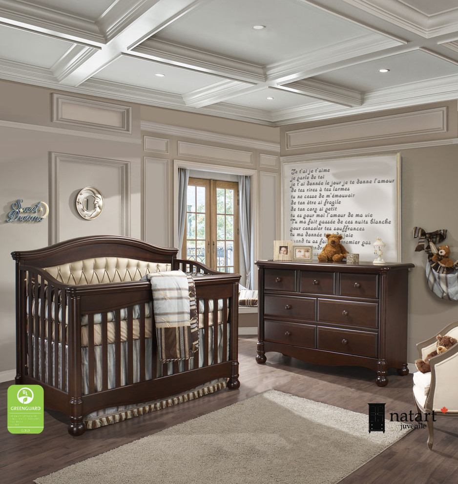 This is an example of a classic nursery for boys in New York with beige walls and dark hardwood flooring.