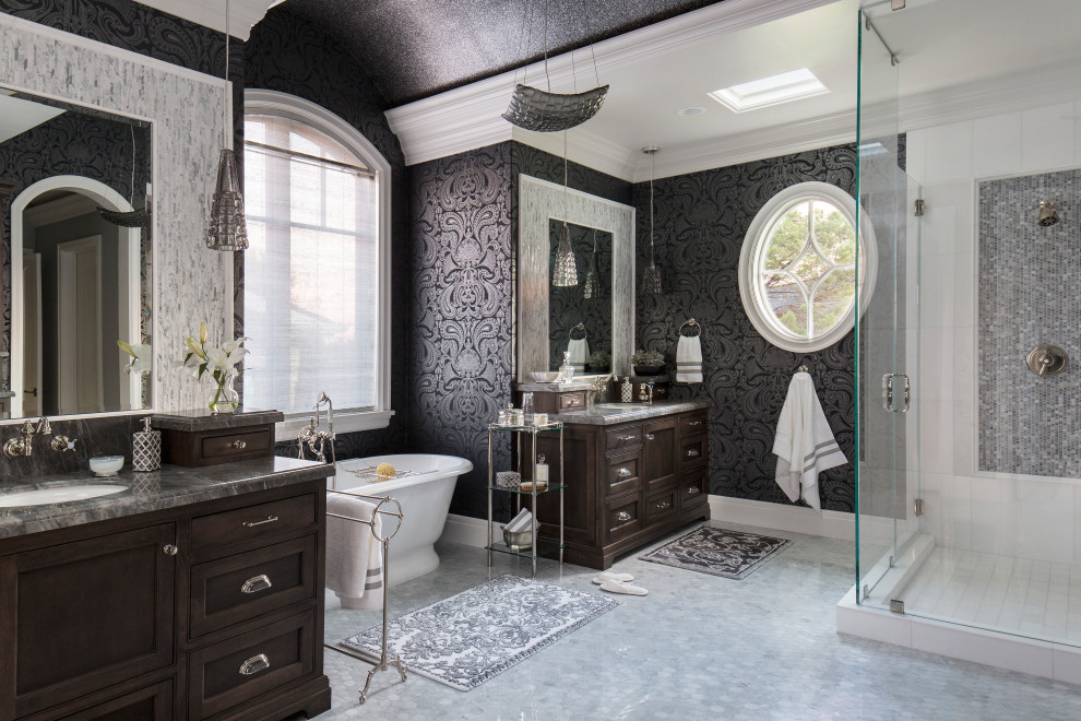 This is an example of a traditional bathroom in San Francisco with recessed-panel cabinets, dark wood cabinets, a corner shower, black tile, grey walls, an undermount sink, grey floor, a hinged shower door, grey benchtops, a double vanity, a built-in vanity and wallpaper.