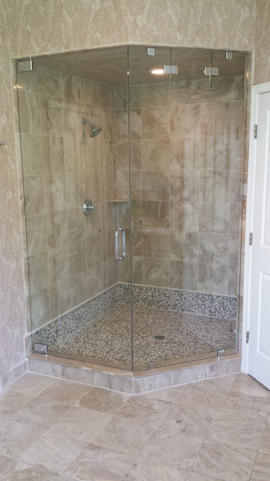 Inspiration for a mid-sized traditional bathroom in New York with a corner shower, brown tile, porcelain tile, brown walls, mosaic tile floors, brown floor and a hinged shower door.
