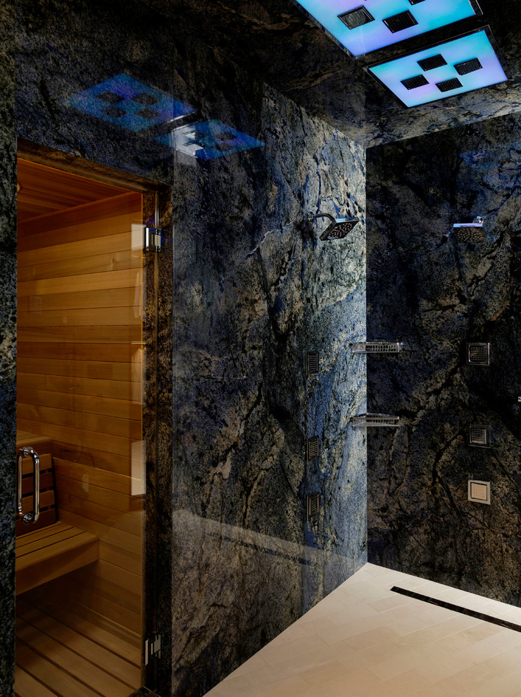 Large contemporary bathroom in Houston with blue tile, with a sauna, a double shower, black walls and travertine floors.