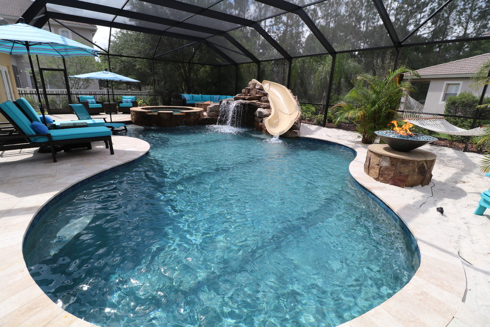 Example of a large transitional indoor concrete paver and custom-shaped water slide design in Tampa