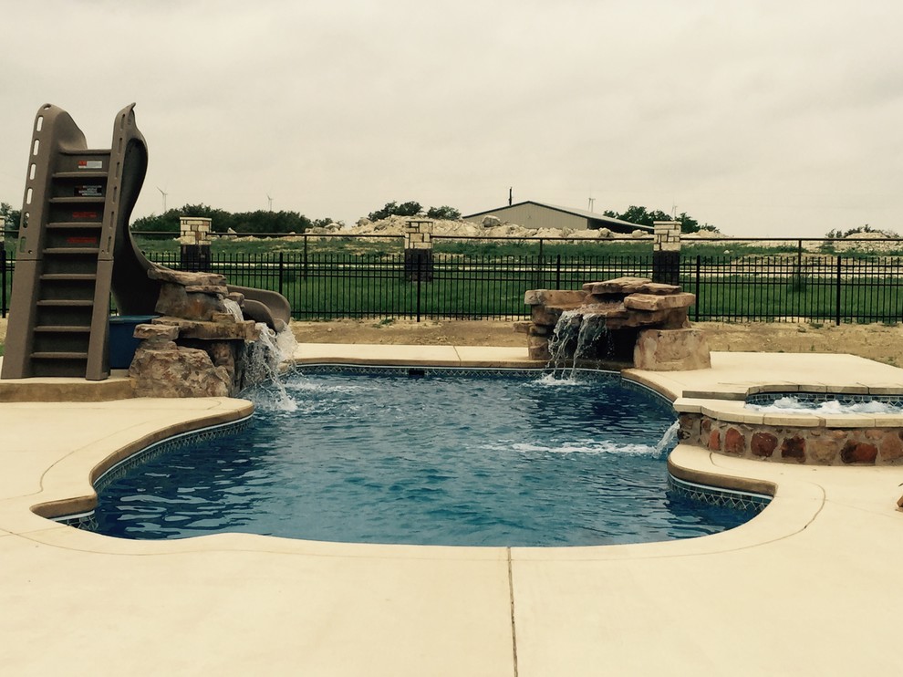 Example of a large minimalist indoor concrete and custom-shaped indoor pool design in Austin