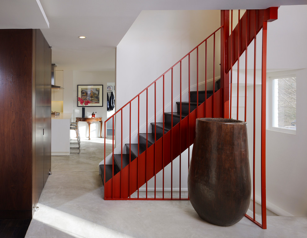 Large modern wood l-shaped staircase in DC Metro with wood risers.