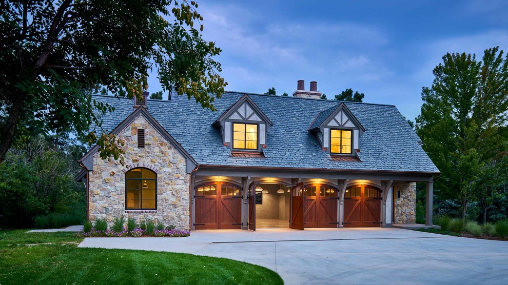 Photo of a large traditional detached four-car garage in Denver.