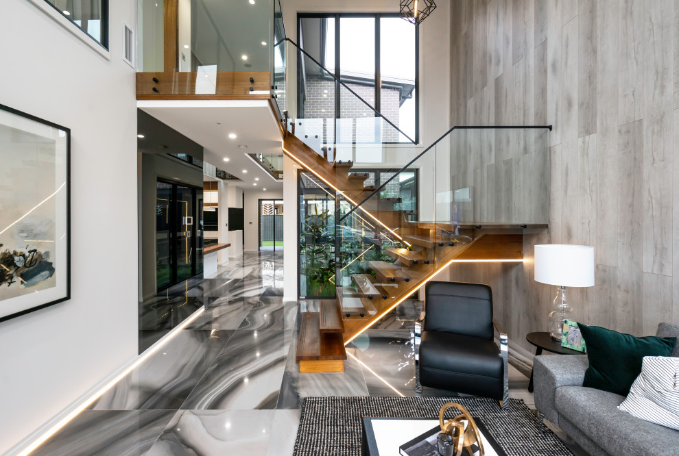 Photo of a contemporary wood staircase in Sydney with open risers and glass railing.