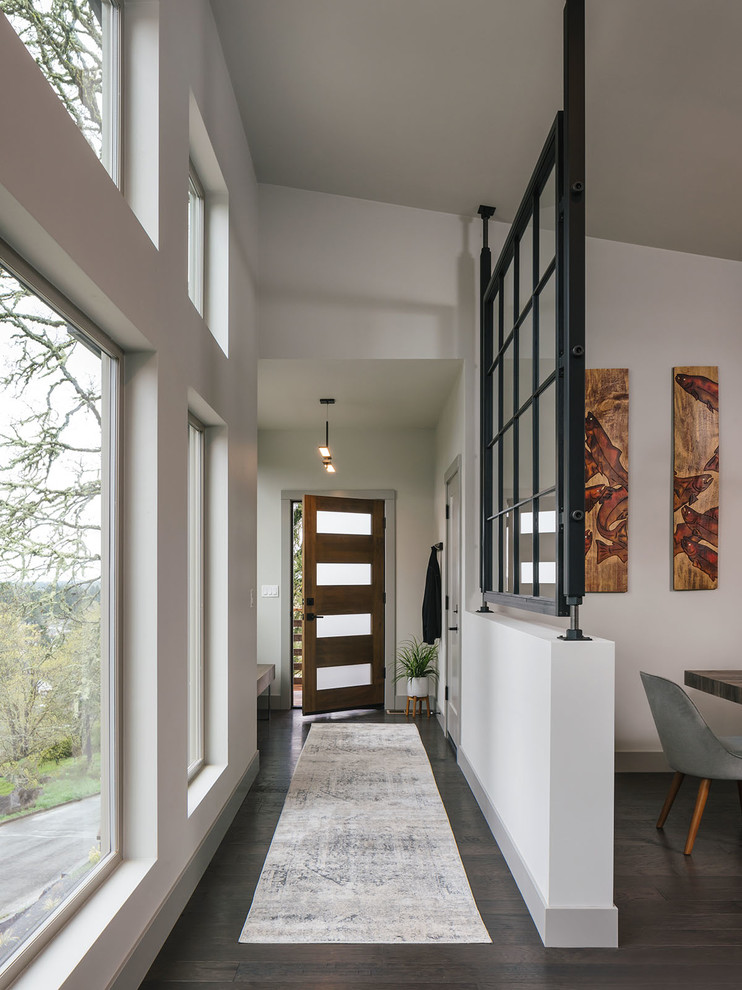 Inspiration for a mid-sized country entry hall in Portland with white walls, dark hardwood floors, a single front door and a dark wood front door.