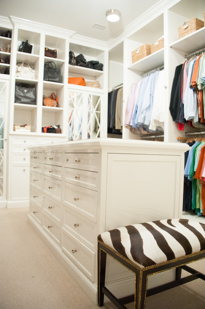 Inspiration for a large traditional women's walk-in wardrobe in Houston with recessed-panel cabinets, white cabinets and carpet.