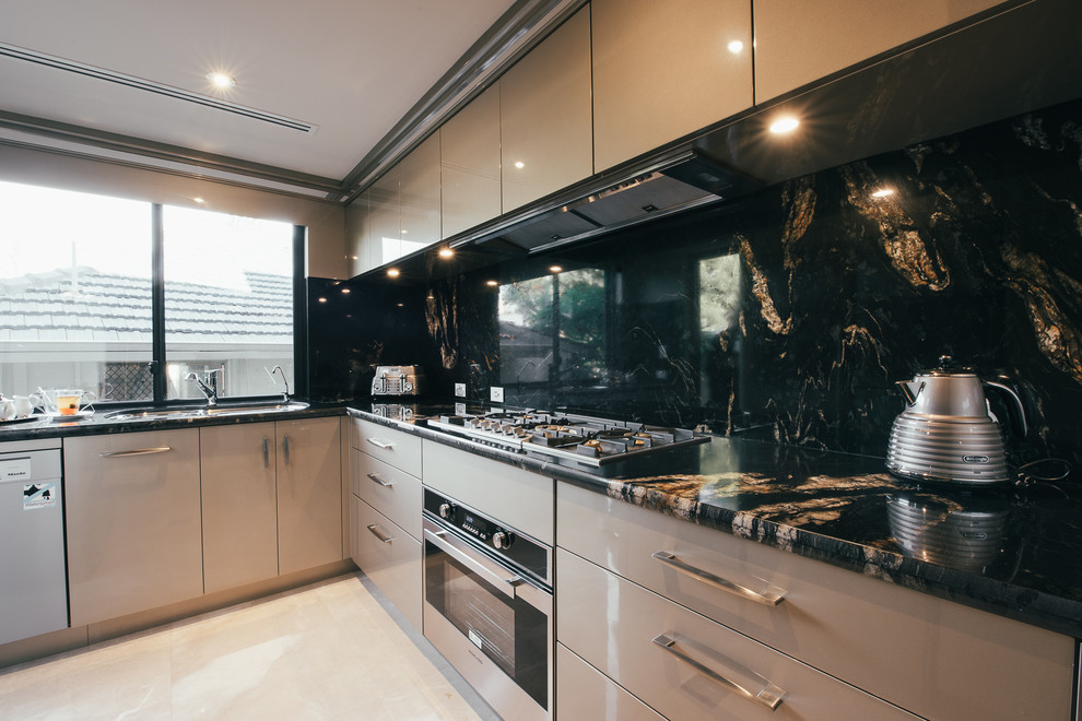 This is an example of a large transitional u-shaped separate kitchen in Perth with a double-bowl sink, beige cabinets, granite benchtops, black splashback, stone slab splashback, stainless steel appliances, marble floors and no island.