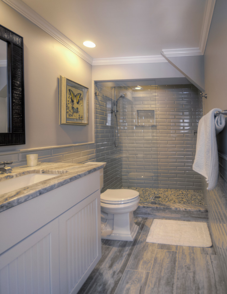 Design ideas for a bathroom in DC Metro with beige tile, ceramic tile and porcelain floors.