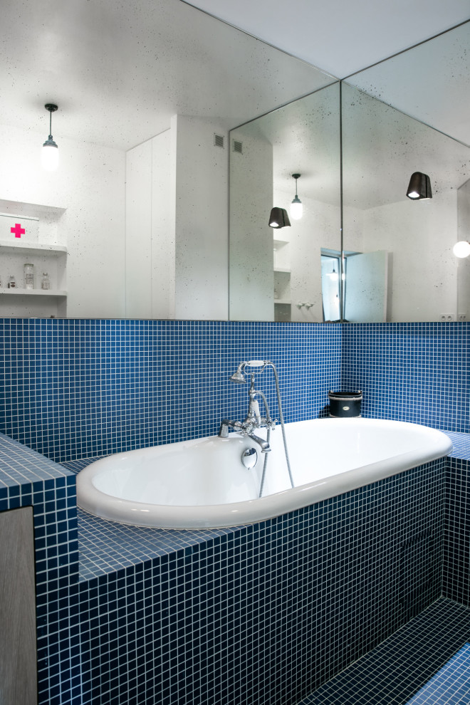 Photo of a scandinavian kids bathroom in Paris with beaded inset cabinets, light wood cabinets, an undermount tub, a curbless shower, blue tile, mosaic tile, blue walls, mosaic tile floors, a drop-in sink, tile benchtops, blue floor, blue benchtops, a niche, a single vanity and a built-in vanity.