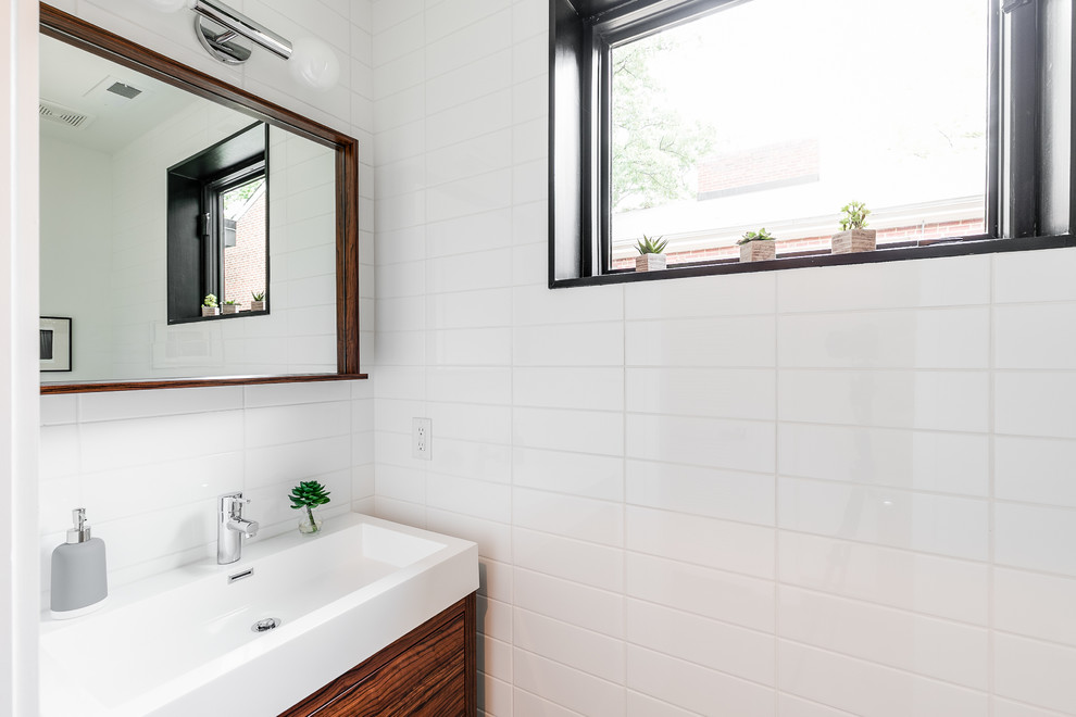 Modern kids bathroom in DC Metro with an alcove shower, white tile and white walls.