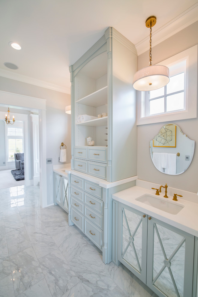 Large contemporary master bathroom in Salt Lake City with an undermount sink, furniture-like cabinets, blue cabinets, engineered quartz benchtops, white tile, grey walls, marble floors and a japanese tub.