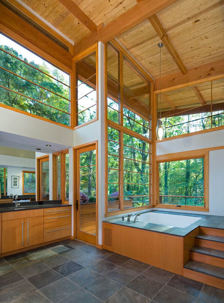 Design ideas for an expansive contemporary master bathroom in Atlanta with flat-panel cabinets, medium wood cabinets, an undermount tub, white walls, slate floors, an undermount sink and granite benchtops.