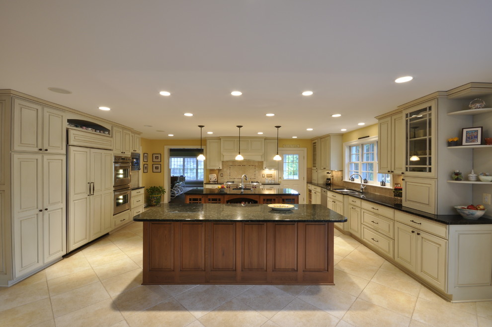 Example of a huge transitional ceramic tile open concept kitchen design in DC Metro with raised-panel cabinets, white cabinets, stainless steel appliances and two islands