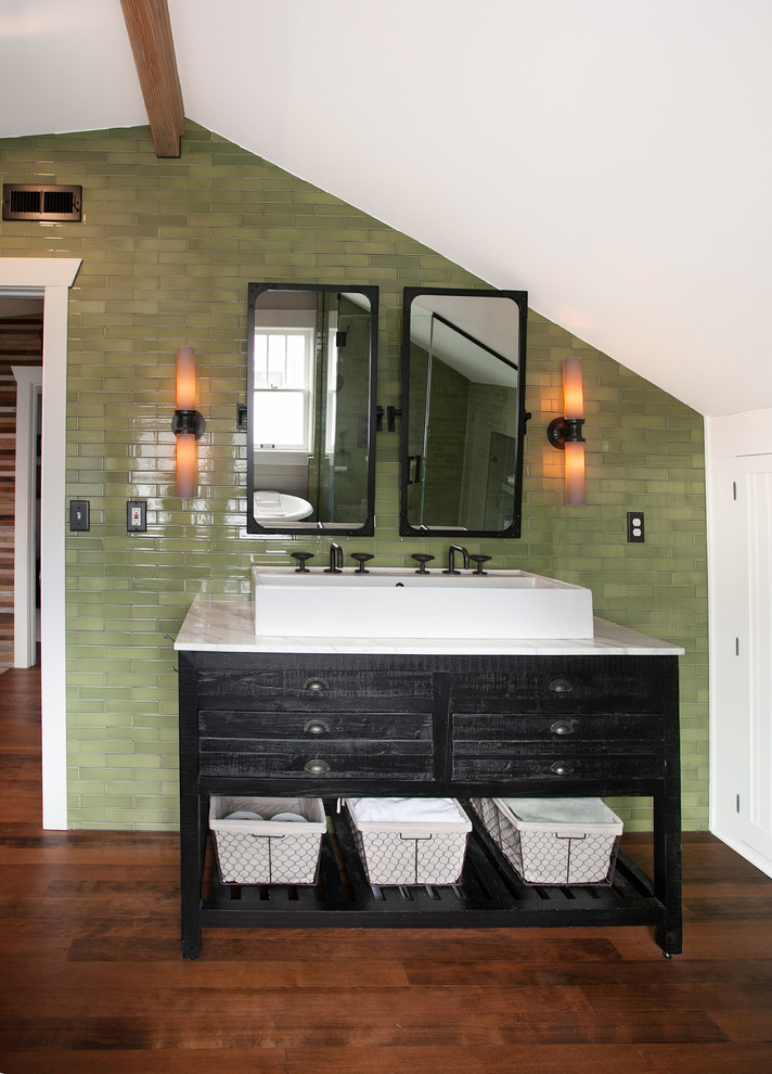 This is an example of a mid-sized eclectic master bathroom in Seattle with furniture-like cabinets, distressed cabinets, a claw-foot tub, a corner shower, a one-piece toilet, green tile, ceramic tile, grey walls, medium hardwood floors, a vessel sink and marble benchtops.