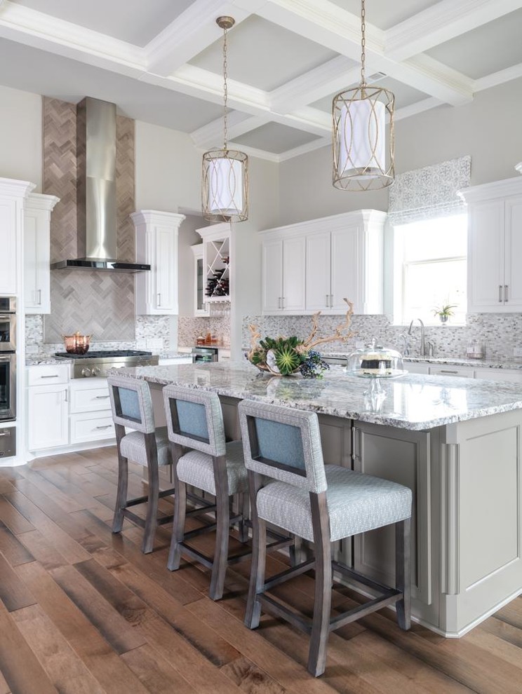 Design ideas for a transitional l-shaped separate kitchen in Dallas with an undermount sink, recessed-panel cabinets, white cabinets, grey splashback, mosaic tile splashback, stainless steel appliances, medium hardwood floors, with island, brown floor and grey benchtop.