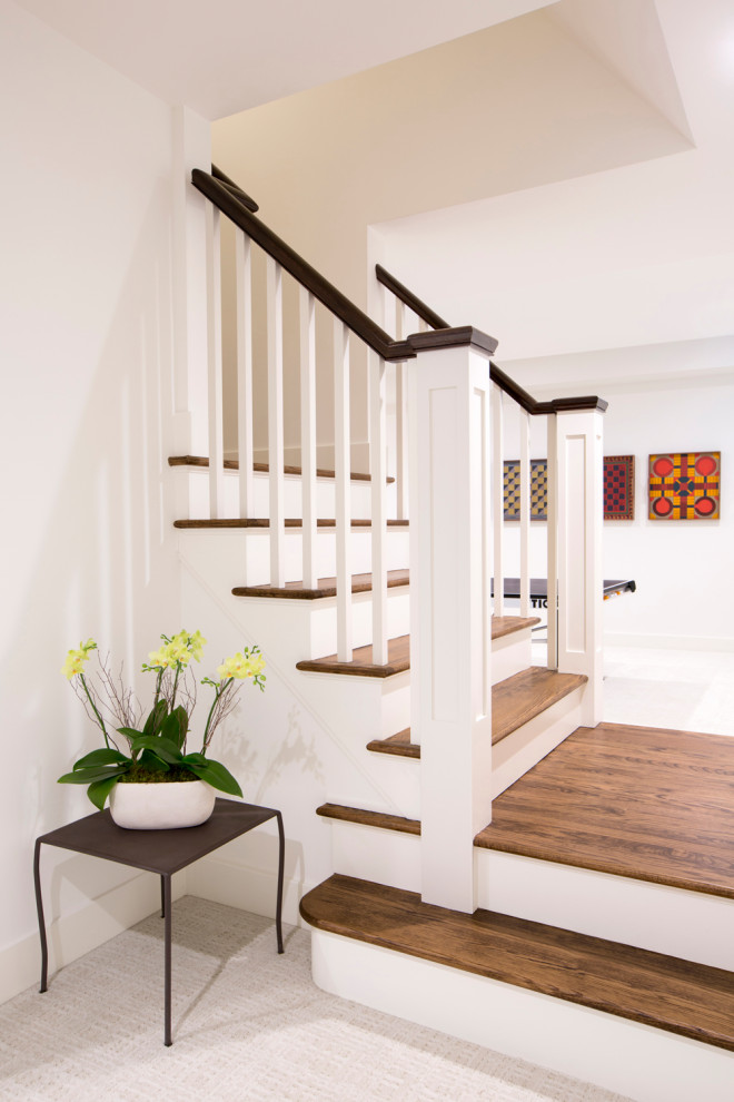 This is an example of a large contemporary look-out basement in New York with a game room, white walls, carpet, white floor and planked wall panelling.