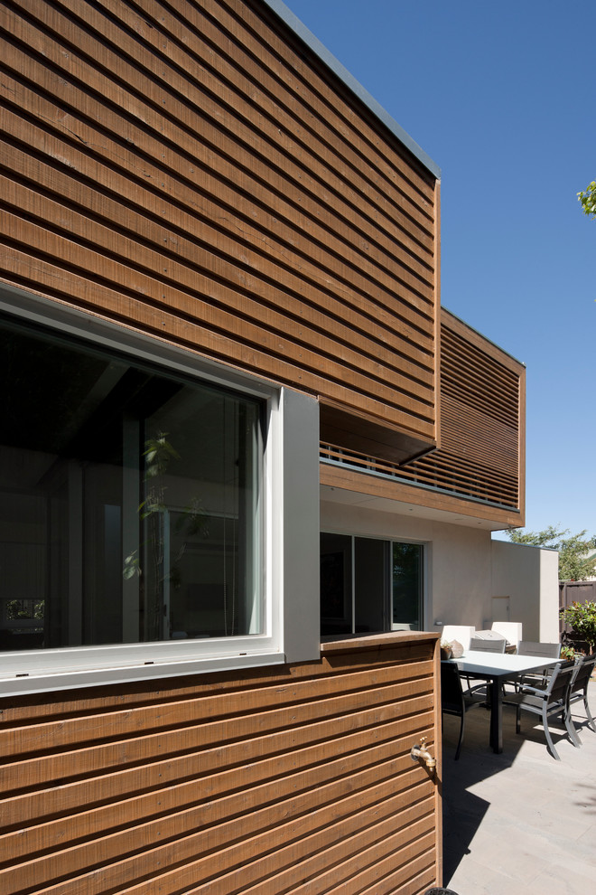 Inspiration for a mid-sized contemporary two-storey exterior in Melbourne with wood siding.