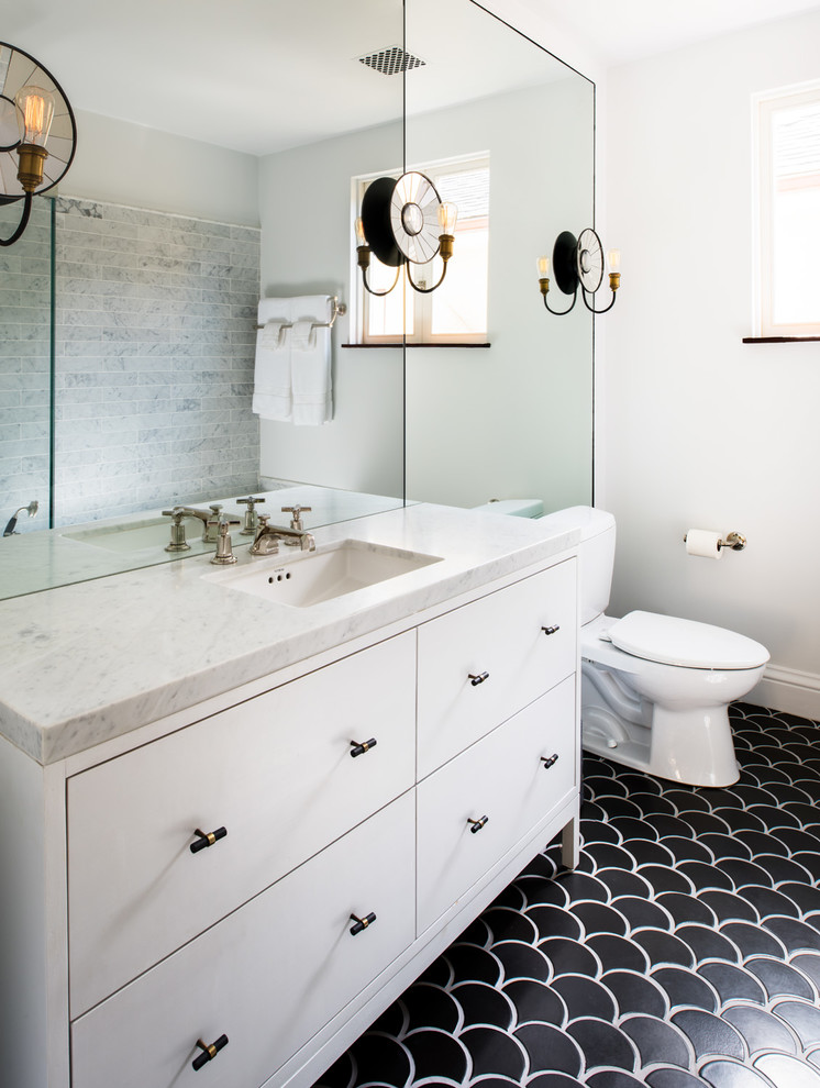 Inspiration for a transitional 3/4 bathroom in San Francisco with flat-panel cabinets, white cabinets, a two-piece toilet, gray tile, subway tile, white walls, an undermount sink, black floor and white benchtops.