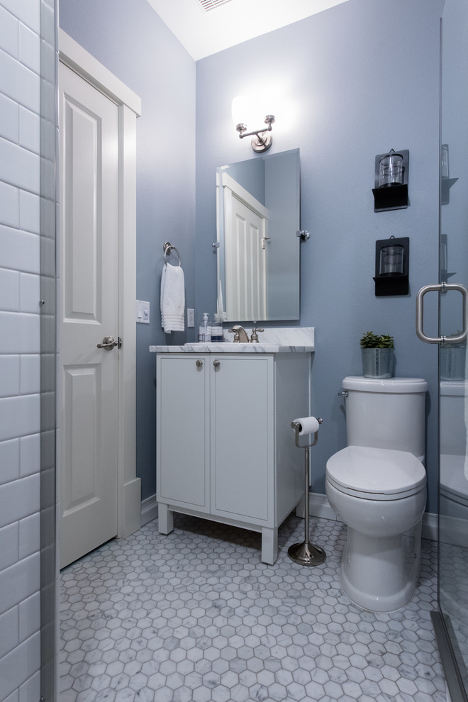 Small transitional powder room in Seattle with shaker cabinets, white cabinets, a two-piece toilet, ceramic floors, a drop-in sink, granite benchtops, white floor, white benchtops, white tile, marble and blue walls.