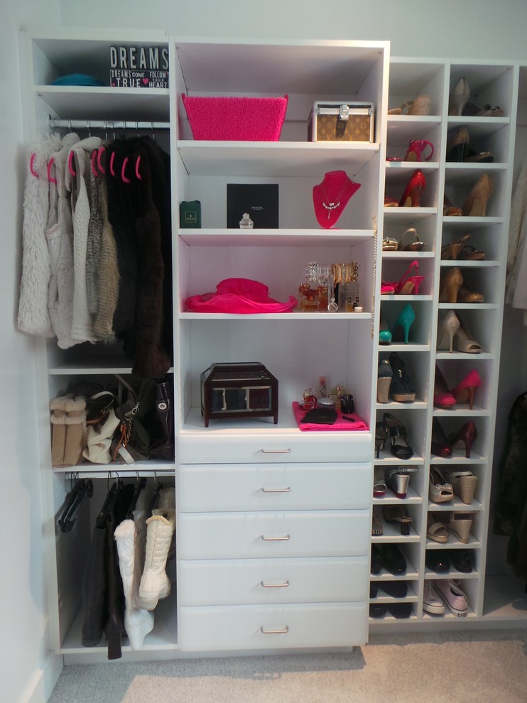 This is an example of a large contemporary dressing room for women in Boston with open cabinets, white cabinets and carpet.