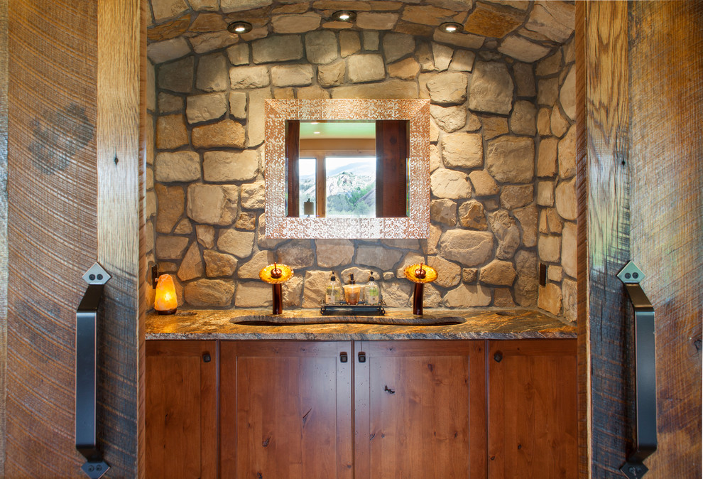 Inspiration for a small country powder room in Denver with shaker cabinets, medium wood cabinets, an undermount sink, granite benchtops and brown benchtops.