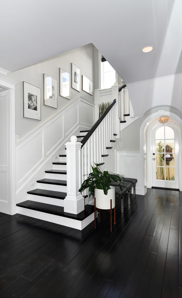 This is an example of a mid-sized traditional wood l-shaped staircase in Orange County with wood risers.
