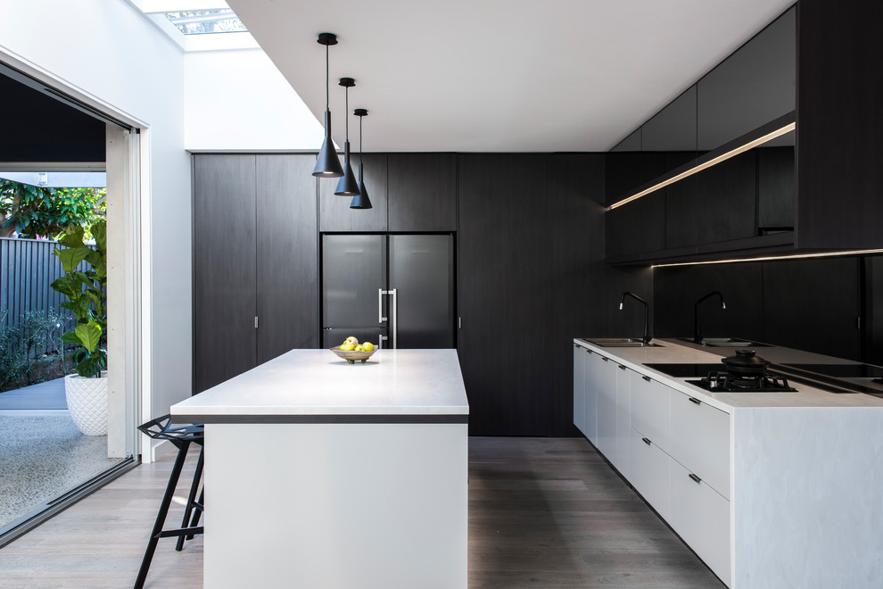 Mid-sized contemporary kitchen in Sydney with flat-panel cabinets, light hardwood floors, with island, a double-bowl sink, black splashback and glass sheet splashback.