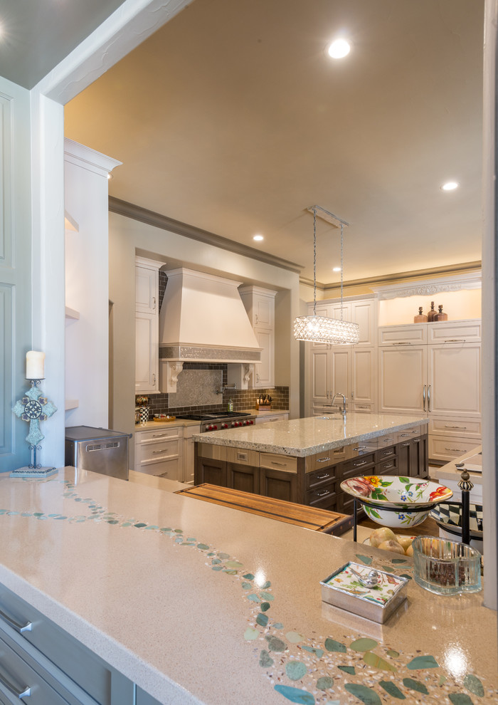 Inspiration for a large traditional u-shaped separate kitchen in Dallas with an undermount sink, raised-panel cabinets, beige cabinets, concrete benchtops, grey splashback, metal splashback, panelled appliances, medium hardwood floors and multiple islands.