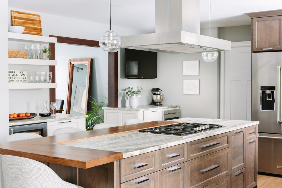 Inspiration for a transitional u-shaped dark wood floor and brown floor eat-in kitchen remodel in Chicago with an undermount sink, shaker cabinets, dark wood cabinets, marble countertops, beige backsplash, stainless steel appliances, an island and beige countertops