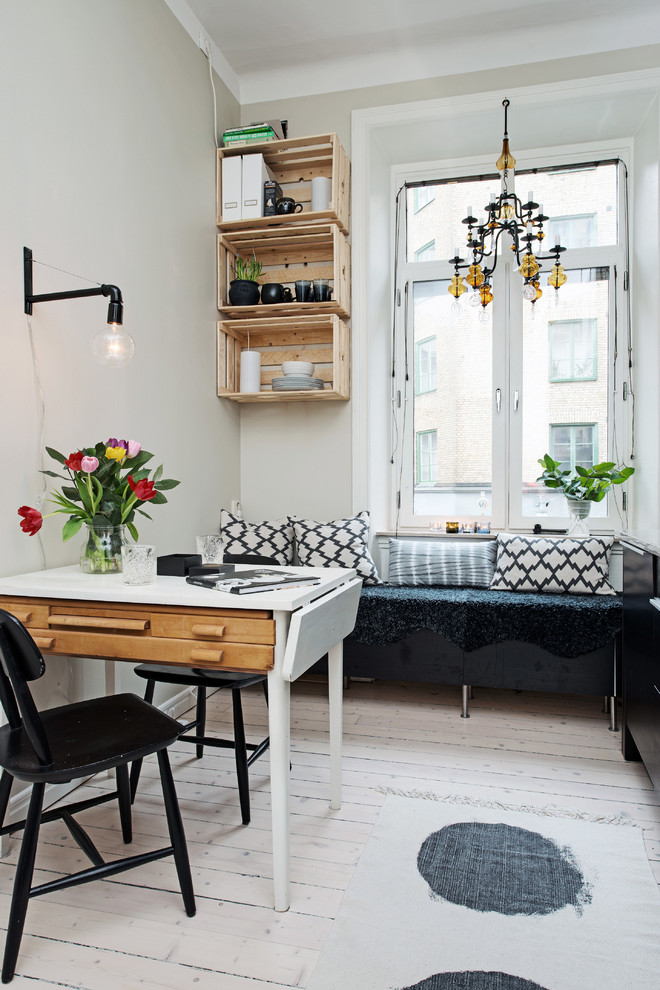 This is an example of a small scandi dining room in Other with beige walls and painted wood flooring.