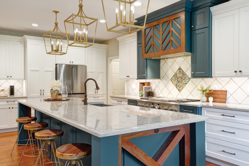 Photo of a large country kitchen/diner in Columbus with a belfast sink, recessed-panel cabinets, all types of cabinet finish, quartz worktops, white splashback, ceramic splashback, stainless steel appliances, medium hardwood flooring, an island, brown floors, white worktops and all types of ceiling.