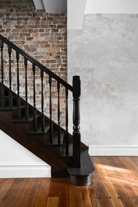 This is an example of a contemporary wood staircase in Sydney with wood risers and wood railing.