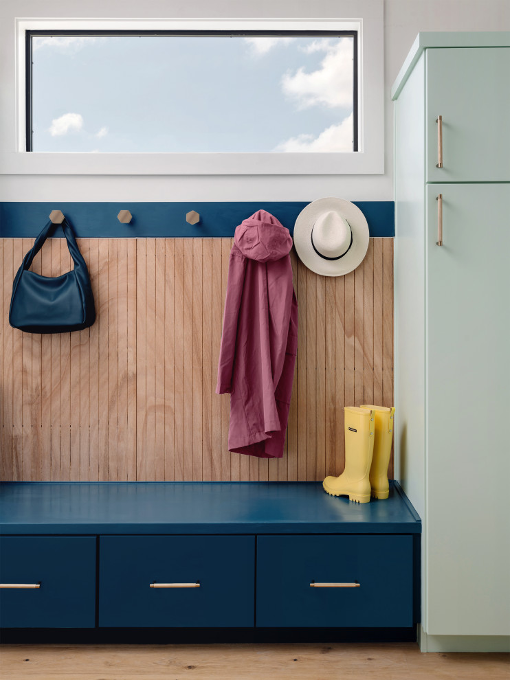 Mudroom - mid-sized 1960s medium tone wood floor, beige floor and wood wall mudroom idea in San Francisco with white walls