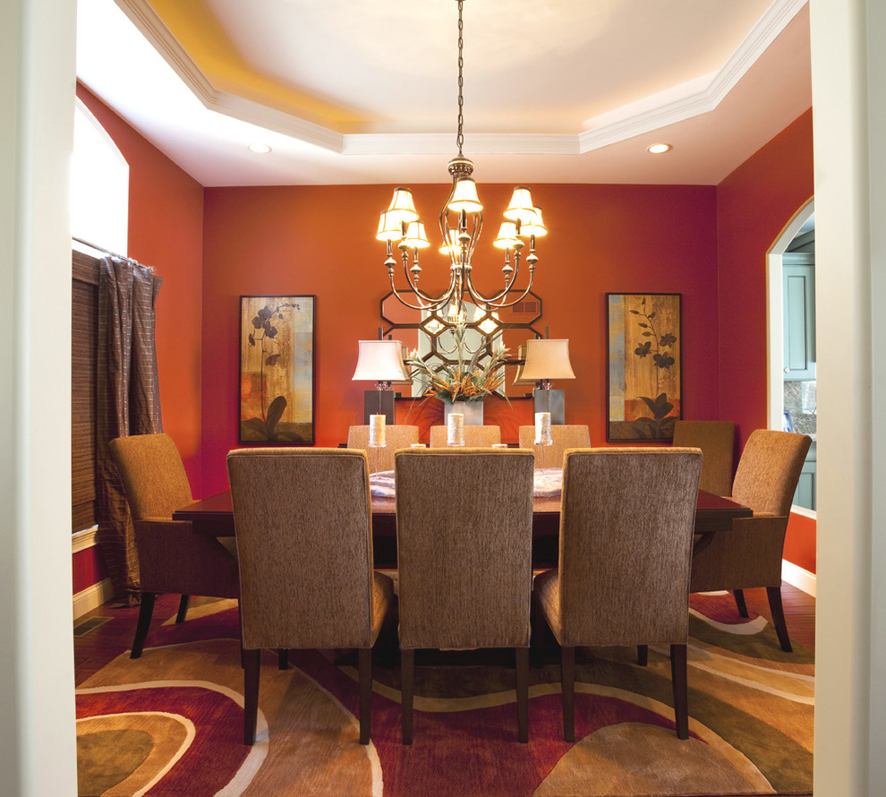 Aménagement d'une salle à manger ouverte sur la cuisine moderne de taille moyenne avec un mur rouge et parquet foncé.
